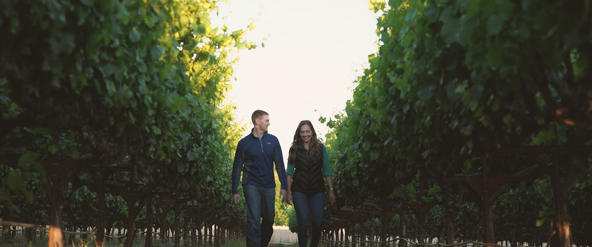 Cliff and Lisa Howard walking through an orchard